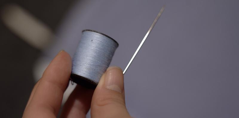Sweater, needle, thread, and wearable tech kit supplies